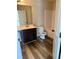 Well-lit bathroom featuring a vanity, toilet, and tub-shower combo at 1307 Clarecastle Ln, Buford, GA 30519