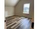 Unfurnished bedroom with luxury vinyl plank flooring and lots of natural light at 1307 Clarecastle Ln, Buford, GA 30519