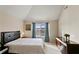 Cozy bedroom with a comfortable bed, vaulted ceiling, and bright natural light at 1307 Clarecastle Ln, Buford, GA 30519