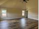 A bright and spacious bedroom with high ceilings, fan and stylish wood-look flooring at 1307 Clarecastle Ln, Buford, GA 30519