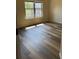 A bright bedroom with stylish wood-look flooring and lots of natural light at 1307 Clarecastle Ln, Buford, GA 30519