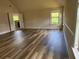 A spacious bedroom with windows and stylish wood-look flooring at 1307 Clarecastle Ln, Buford, GA 30519