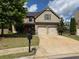 Traditional two-story home with a two-car garage, well-maintained lawn, and inviting curb appeal at 1307 Clarecastle Ln, Buford, GA 30519