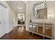 Elegant foyer with hardwood floors, designer mirror, and arched doorway to the spacious living area at 1307 Clarecastle Ln, Buford, GA 30519