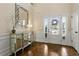 Bright foyer with hardwood floors, stylish mirror, and ample natural light, creating an inviting space at 1307 Clarecastle Ln, Buford, GA 30519