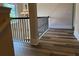 A staircase with modern railings and wood-look floors for an updated look at 1307 Clarecastle Ln, Buford, GA 30519