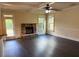 Bright living room featuring a stone fireplace and a ceiling fan at 1307 Clarecastle Ln, Buford, GA 30519