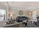 Comfortable living room with neutral tones, two sofas, and a decorative clock on the wall at 1307 Clarecastle Ln, Buford, GA 30519