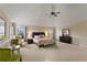 A spacious main bedroom with natural light, neutral tones, and a ceiling fan at 1307 Clarecastle Ln, Buford, GA 30519