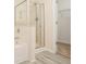 Bathroom featuring a glass enclosed shower, wood plank flooring, and a bathtub at 2279 Hawks Bluff Trl, Lawrenceville, GA 30044