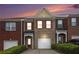Charming brick townhome with a one-car garage and a well-manicured front yard at 2279 Hawks Bluff Trl, Lawrenceville, GA 30044