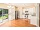 Modern kitchen with stainless steel appliances, white cabinets, and hardwood floors at 2279 Hawks Bluff Trl, Lawrenceville, GA 30044