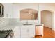 Bright kitchen with white cabinets, stainless steel appliances, and breakfast bar at 2279 Hawks Bluff Trl, Lawrenceville, GA 30044