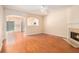 Bright living room featuring hardwood floors and a fireplace, open to the kitchen at 2279 Hawks Bluff Trl, Lawrenceville, GA 30044
