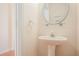 Powder room with a pedestal sink, a mirror, and natural walls at 2279 Hawks Bluff Trl, Lawrenceville, GA 30044