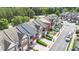 Aerial view of townhomes from street with manicured lawns and trees at 2279 Hawks Bluff Trl, Lawrenceville, GA 30044