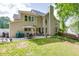 Large backyard featuring a patio, green lawn, and established trees, creating a serene outdoor space at 352 Hickory Haven Ter, Suwanee, GA 30024