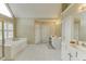 This primary bathroom features a soaking tub, vanity, and separate shower with ample natural light at 352 Hickory Haven Ter, Suwanee, GA 30024