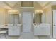 Bright bathroom with double vanity, white cabinets, mirrors and modern lighting at 352 Hickory Haven Ter, Suwanee, GA 30024