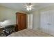 Bedroom with a ceiling fan, a large window, a desk, wardrobe and walk in closet at 352 Hickory Haven Ter, Suwanee, GA 30024