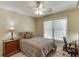 Relaxing bedroom with a ceiling fan, a large window, and traditional furnishings at 352 Hickory Haven Ter, Suwanee, GA 30024