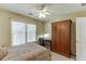 Bedroom with a ceiling fan, a large window, a desk and wardrobe at 352 Hickory Haven Ter, Suwanee, GA 30024
