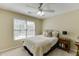 Comfortable bedroom with a ceiling fan, double bed and a window providing natural light at 352 Hickory Haven Ter, Suwanee, GA 30024
