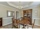 Elegant dining room featuring a chandelier, tray ceiling, and hardwood floors at 352 Hickory Haven Ter, Suwanee, GA 30024