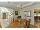 Elegant dining room featuring a chandelier, tray ceiling, and hardwood floors at 352 Hickory Haven Ter, Suwanee, GA 30024
