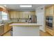 Bright kitchen featuring stainless steel appliances, wood cabinets, and a functional center island at 352 Hickory Haven Ter, Suwanee, GA 30024