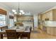 Eat-in kitchen with stainless steel appliances, light wood cabinets, and a dining area at 352 Hickory Haven Ter, Suwanee, GA 30024