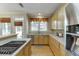 Charming kitchen with wood cabinets, stainless steel appliances and a view to the outside at 352 Hickory Haven Ter, Suwanee, GA 30024
