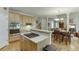 Open kitchen with an island cooktop overlooking the eat-in kitchen and living room at 352 Hickory Haven Ter, Suwanee, GA 30024