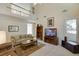 Spacious living room with a balcony view, complete with a bookcase and entertainment center at 352 Hickory Haven Ter, Suwanee, GA 30024