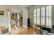 Open-concept living room with hardwood floors, shutters, and natural light at 352 Hickory Haven Ter, Suwanee, GA 30024