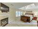 This main bedroom features a fireplace, tray ceiling, and a large window for natural light at 352 Hickory Haven Ter, Suwanee, GA 30024