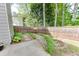 Side yard features landscaping and stepping stones, with a wood fence at 352 Hickory Haven Ter, Suwanee, GA 30024