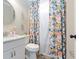 Cozy bathroom featuring floral curtain, modern round mirror, and white vanity at 39 Summer Nw Pl, Cartersville, GA 30121