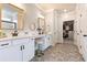 Bright bathroom featuring dual vanities, decorative mirrors, and a walk-in closet at 39 Summer Nw Pl, Cartersville, GA 30121