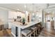 Kitchen island with seating, modern pendant lights, and built-in wine cooler at 39 Summer Nw Pl, Cartersville, GA 30121