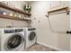 Clean laundry room showcasing a modern washer and dryer with rustic shelving at 39 Summer Nw Pl, Cartersville, GA 30121