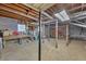 Unfinished basement with exposed ceiling, concrete floor, and support beams ready for storage or customization at 4856 Rock Haven Dr, Lilburn, GA 30047