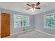 Comfortable bedroom with light blue walls, and big windows letting in lots of natural light at 4856 Rock Haven Dr, Lilburn, GA 30047