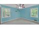 Aqua bedroom features dual windows, carpet flooring and a ceiling fan at 4856 Rock Haven Dr, Lilburn, GA 30047