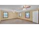 Large bedroom with three windows, carpet floors, ceiling fans, and natural light at 4856 Rock Haven Dr, Lilburn, GA 30047
