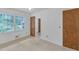 This bedroom offers serene views through a large window, neutral carpet, and easy bathroom access at 4856 Rock Haven Dr, Lilburn, GA 30047