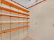 Walk-in closet featuring multiple rows of wood shelving, providing ample storage space at 4856 Rock Haven Dr, Lilburn, GA 30047