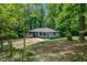 Secluded single-story home nestled among mature trees offering ultimate privacy and a tranquil setting at 4856 Rock Haven Dr, Lilburn, GA 30047