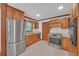 Well-equipped kitchen featuring stainless steel appliances, wooden cabinetry, and ample counter space at 4856 Rock Haven Dr, Lilburn, GA 30047