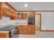 Traditional kitchen with wood cabinets, neutral countertops, and a modern black range oven at 4856 Rock Haven Dr, Lilburn, GA 30047